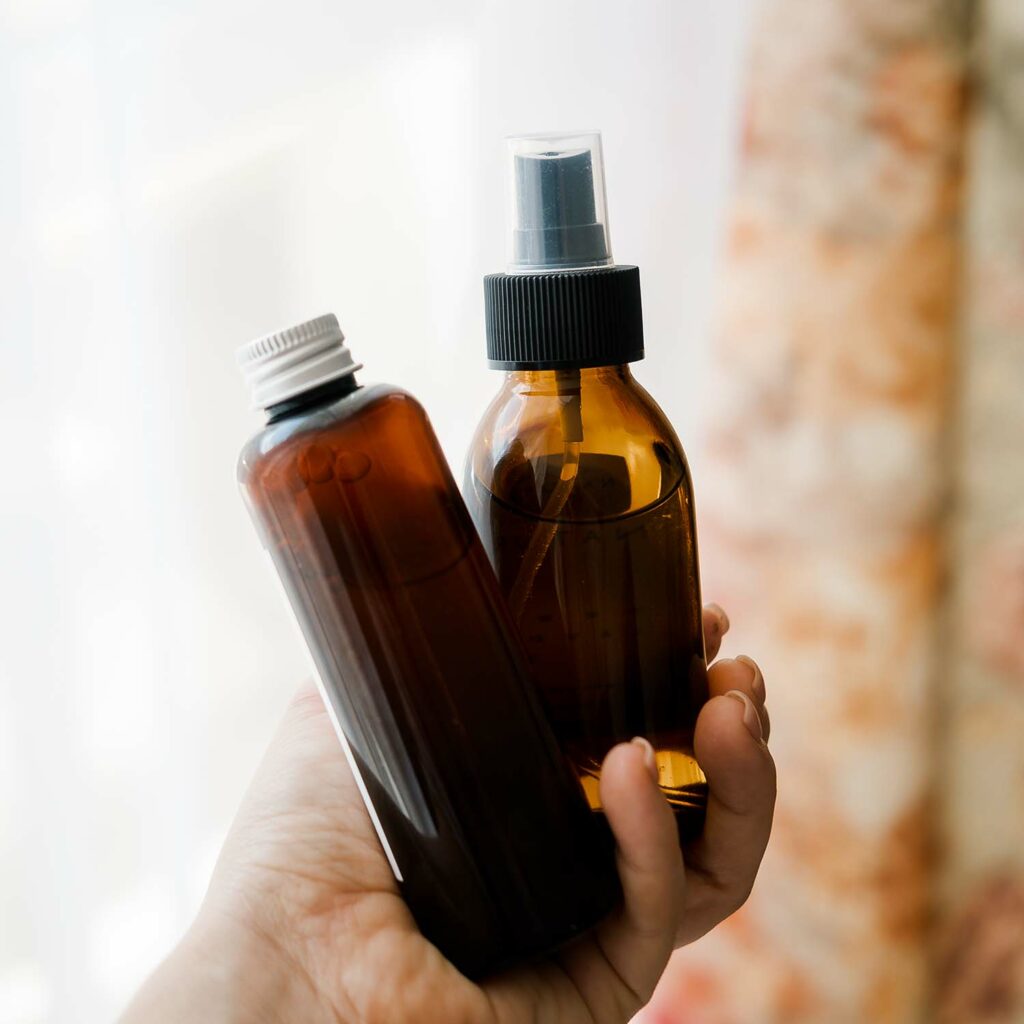 two-cosmetic-bottles-in-womans-hands-CQK35WA.jpg